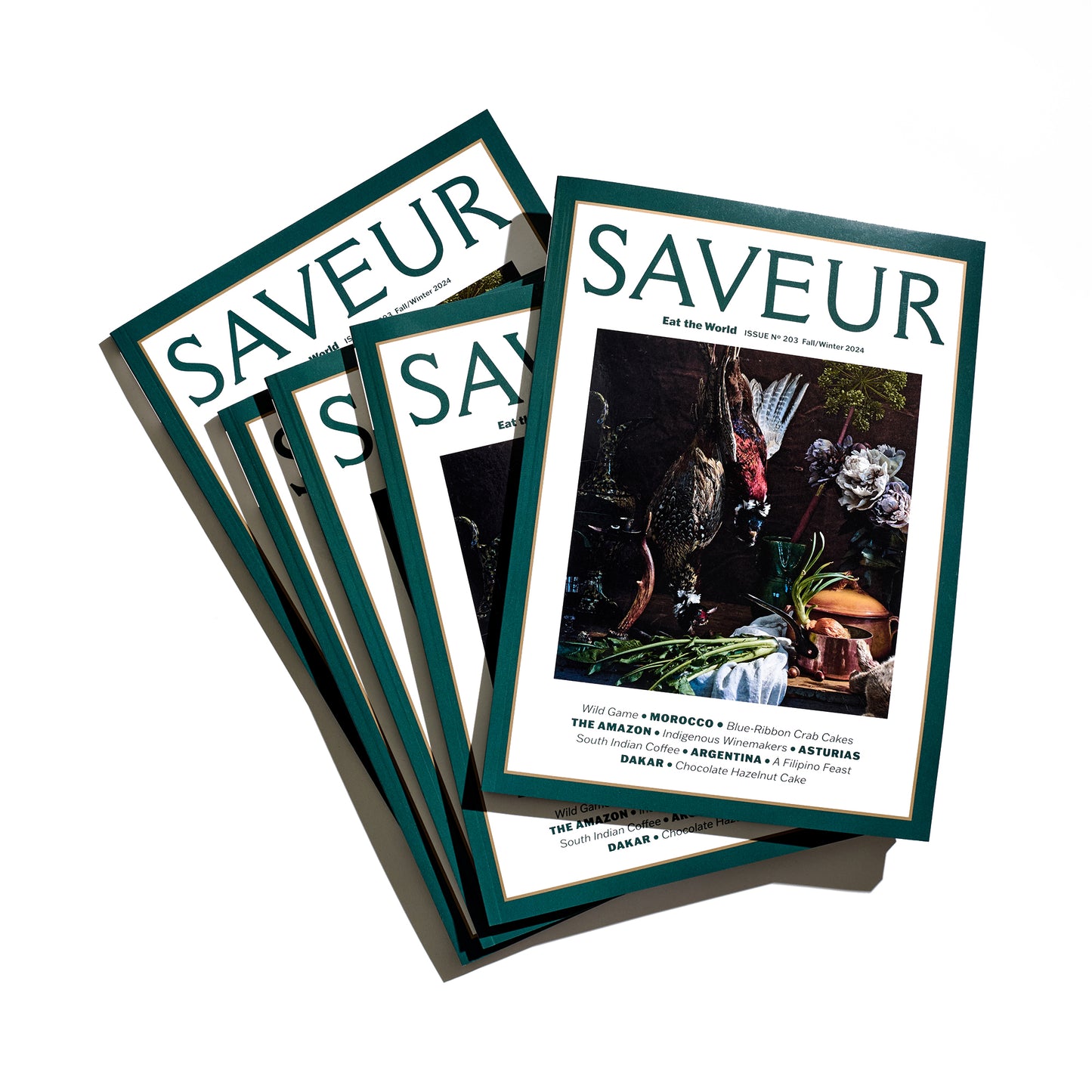 Stack of SAVEUR magazines issue No. 203; Fall/Winter 2024, on white background