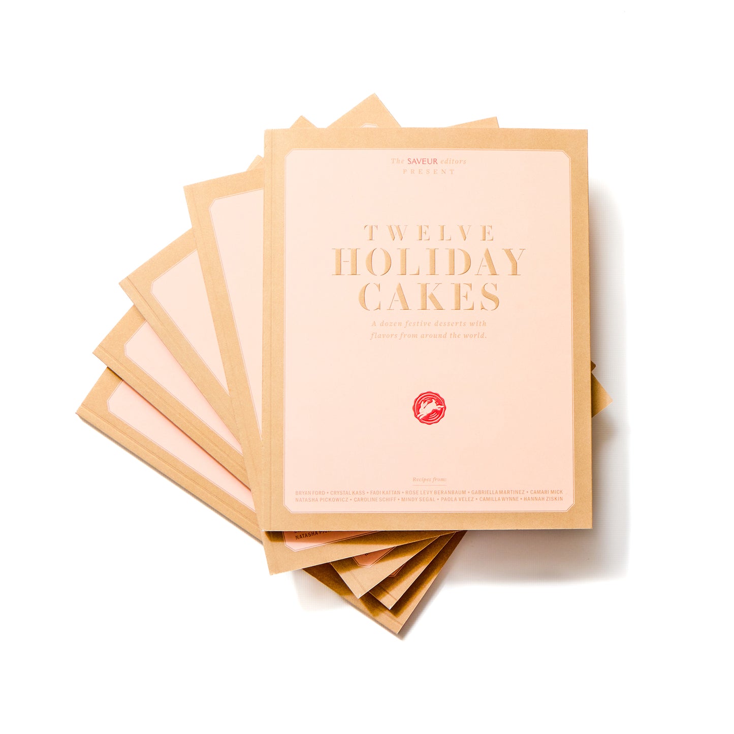 Stack of SAVEUR Twelve Holiday Cakes books on white background