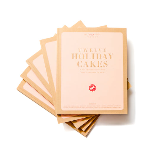 Stack of SAVEUR Twelve Holiday Cakes books on white background
